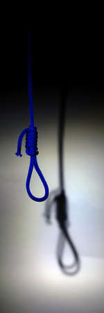 blurred shadow of the loop of the gallows on the light wall, darkness, reduced color