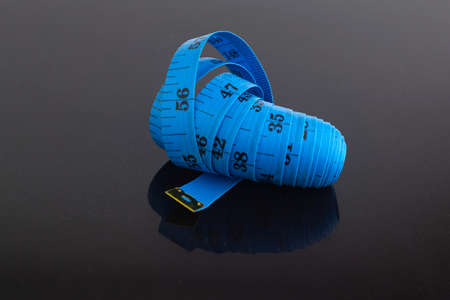 measuring blue tape isolated on black background. short focusの写真素材
