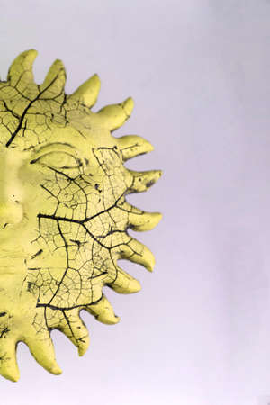 travel artifacts: antique ceramic sun with prominences, on a light background, short focusの写真素材