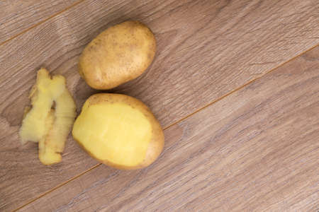 veganism: two eco potatoes on a wooden tableの写真素材