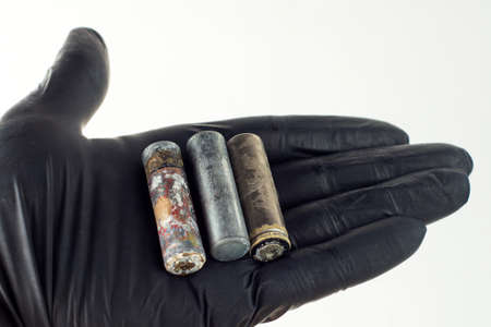 deadly environmental pollution from hazardous waste industry concept: mercury and cadmium old batteries in handの写真素材