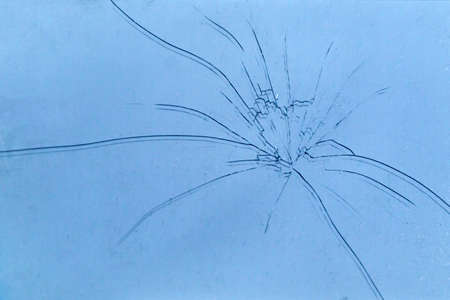 background: phone glass covered with concentric cracks, dust particles, toning