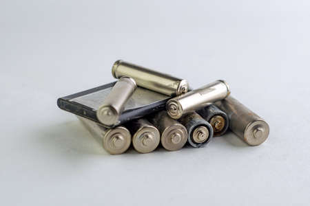 recycling of mercury and cadmium: several batteries are isolated on white, short focus, toningの写真素材