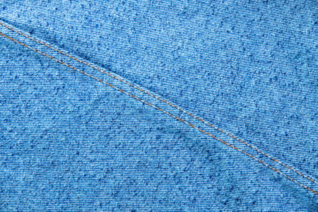 classic grunge background: real old american denim, close, scar and thread, short focus, top viewの写真素材