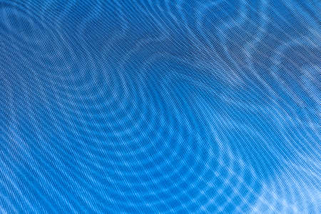 abstract background: unique wavy pattern of overlaying two grids, blurry and tinted to classic blue,...
