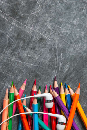multicolored school supplies lie on black chalkboard, short focus, partial blurの写真素材