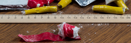evidence of smuggling traffic: packages of unknown drugs next to the forensic scale