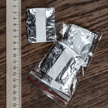 evidence of smuggling traffic: packaging of an unknown drug next to the forensic scaleの写真素材