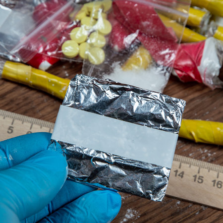 evidence of smuggling traffic: Packaging of a narcotic substance in the hand of a forensic expert...