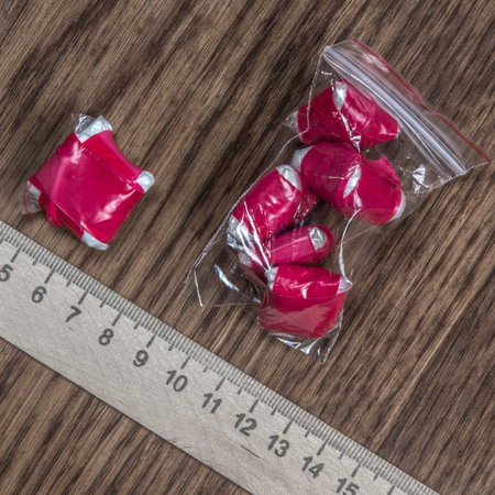 evidence of smuggling traffic: packaging of an unknown drug next to the forensic scaleの写真素材