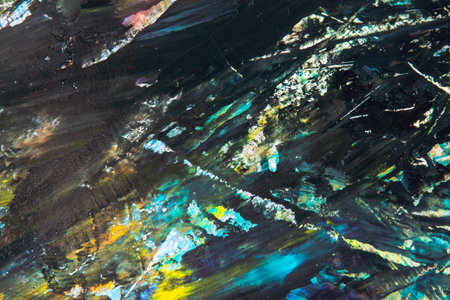 colorful creative motley background: smudged residues of oil paints on a wooden palette, short...