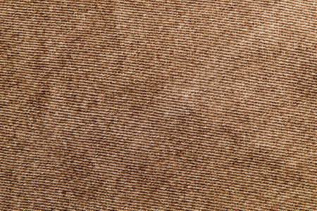 fabric grunge background, real cotton denim brown, wrinkled, frayed, closeの写真素材