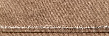 fabric grunge background, real cotton denim, brown, wrinkles, frayed, seam on the canvas, closeの写真素材