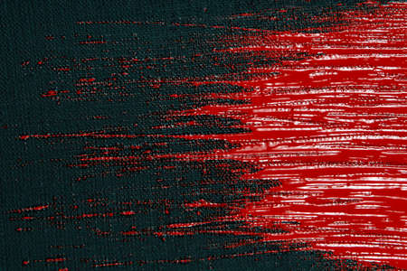 abstract creative background: red spots, strokes and splashes of colored primer when toning a black canvas, a temporary object.の写真素材