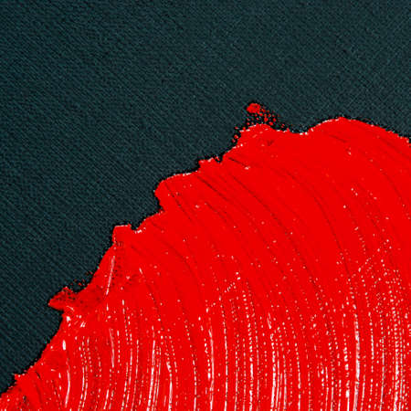 abstract creative background: red spots, strokes and splashes of colored primer when toning a black canvas, a temporary object.の写真素材