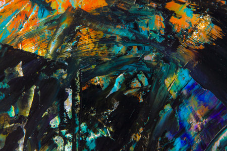 colorful creative motley background: smudged residues of oil paints on a wooden palette, short...