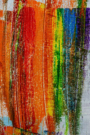 several strokes of multi-colored paint depict a frag of the LGBT community on a light surface. short...