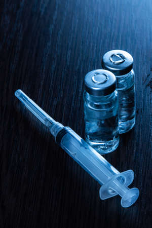 2 doses of Sars-Kov-2 coronavirus vaccine in transparent glass ampoules, covered with frost and a...