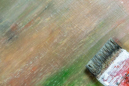 abstract colored creative background - rough linen canvas unevenly covered with multi-colored primers, reflections of light, wide brush. Toning, blur. Temporary object.の写真素材