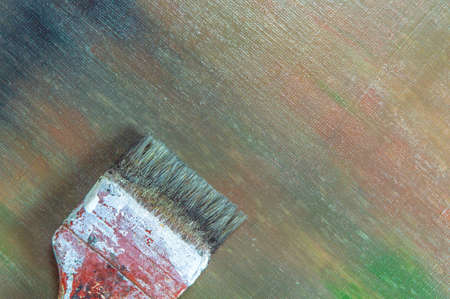 abstract colored creative background - rough linen canvas unevenly covered with multi-colored primers, reflections of light, wide brush. Toning, blur. Temporary object.の写真素材
