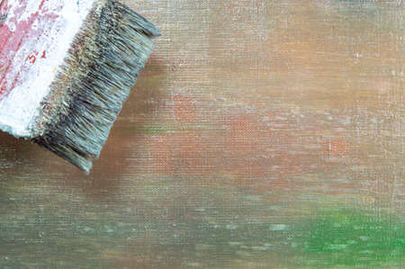 abstract colored creative background - rough linen canvas unevenly covered with multi-colored primers, reflections of light, wide brush. Toning, blur. Temporary object.の写真素材