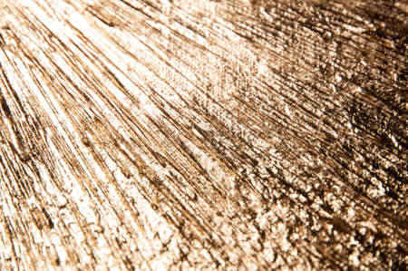 area of radially crumpled gold patina, flare effect, short focus