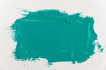 wide of green paint on a white coarse weave art gauze stroke close-up, toning, free spaceの写真素材