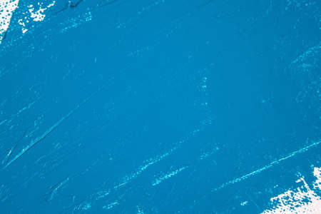 saturated blue abstract background, applied toning primer on a white surface