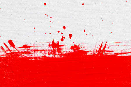 thick red bright acrylic paint applied unevenly on a light surfaceの写真素材