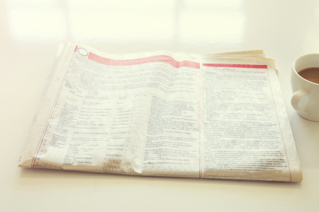 Newspaper with coffee on tableの写真素材