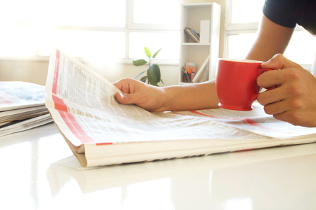 Man hands reading newspaperの写真素材