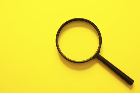 Ä°solated magnifier on yellow backgroundの写真素材