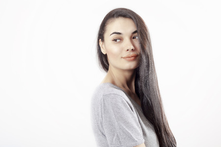 Young beautiful portrait woman on gray backgroundの写真素材