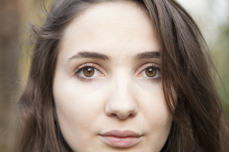 Beautiful young woman portrait in outdoorsの写真素材