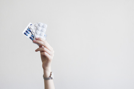 Time to take pills for with woman hand arm raised