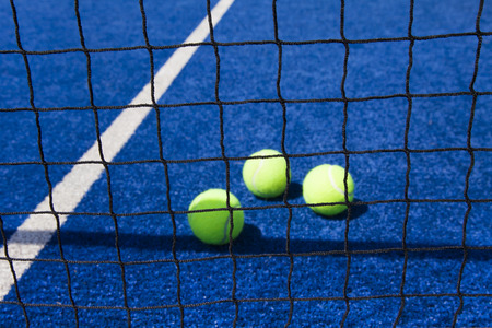 Tennis ball with racket on court