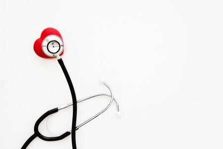 Red heart and a stethoscope on white backgroundの写真素材