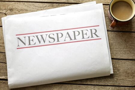 Newspaper and coffee on wooden backgroundの写真素材