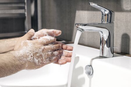 Washing hands rubbing with soap man for corona virus prevention, hygiene to stop spreading coronavirus.の写真素材