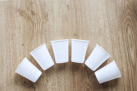 Set of plastic cups on wooden backgroundの写真素材