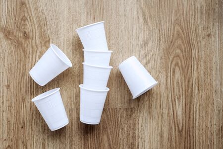 Set of plastic cups on wooden backgroundの写真素材