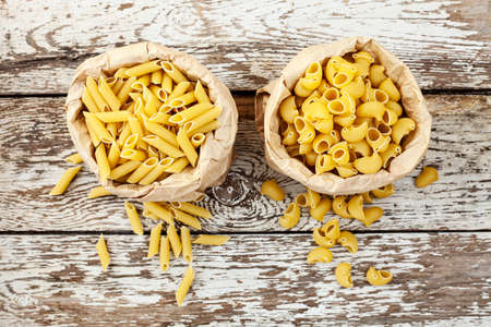 Various of pasta on wooden background,Top viewの写真素材