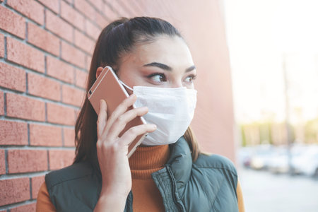 Portrait young using smartphone on background concrete brick wall.の写真素材