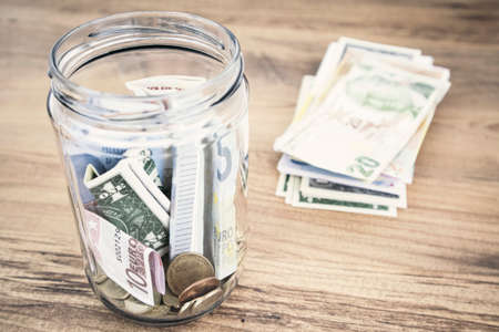 Image of coin in a clear bottle, saving conceptの写真素材