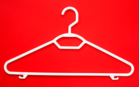 Coat hanger on red background.の写真素材