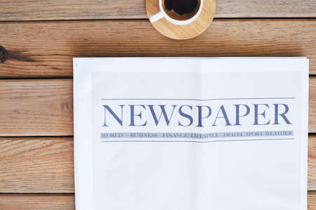 Newspaper with coffee on the tableの写真素材