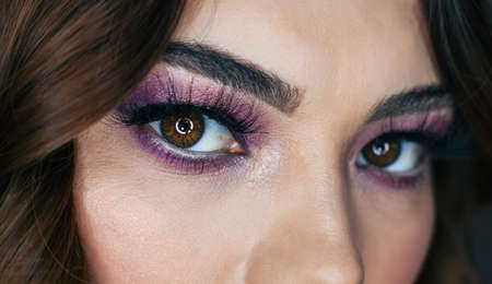 Closeup portrait of beautiful woman with bright make-up and pink lips. Attractive model with a pink lipstick.の写真素材