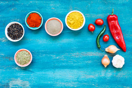 Colourful various vegatable and spices for cooking on blue background