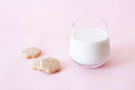 Cookies and glass of milk in pink backgroundの写真素材