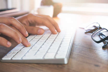Hands of an office woman typingの写真素材